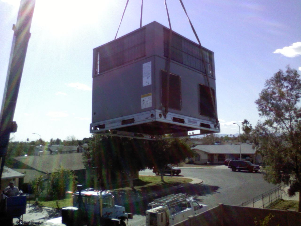 Heil heat pump unit hoisted up to roof by crane